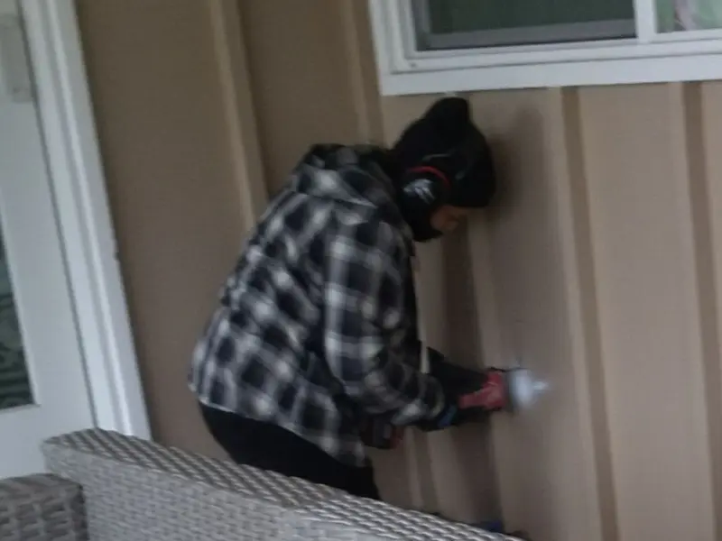 Professional electrician installing an exterior outlet in Hamlet